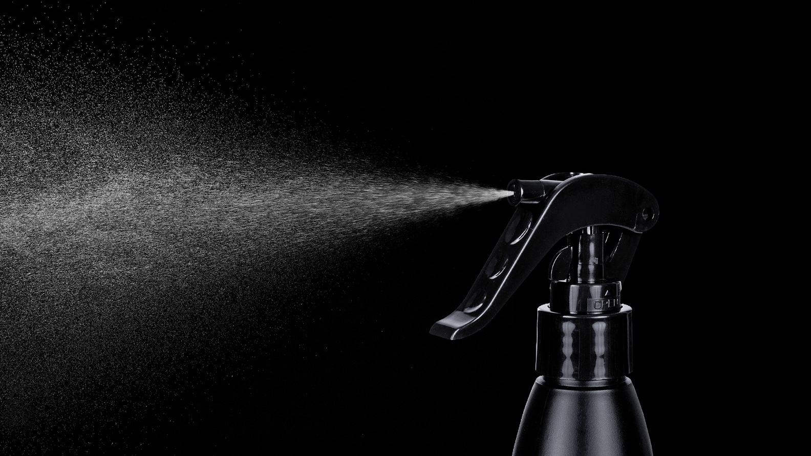 Close-up of a fine fragrance mist released from a home and car perfume spray bottle